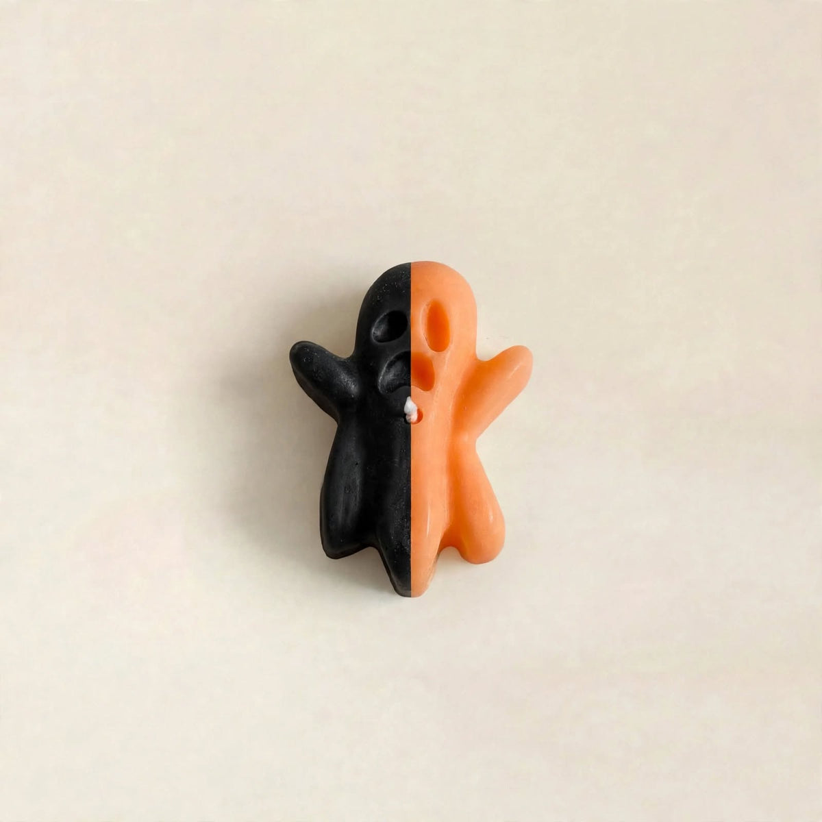 Banshee handmade Halloween candle by Glowbaltic, hand-poured black and orange rapeseed wax ghost candle with raised arms