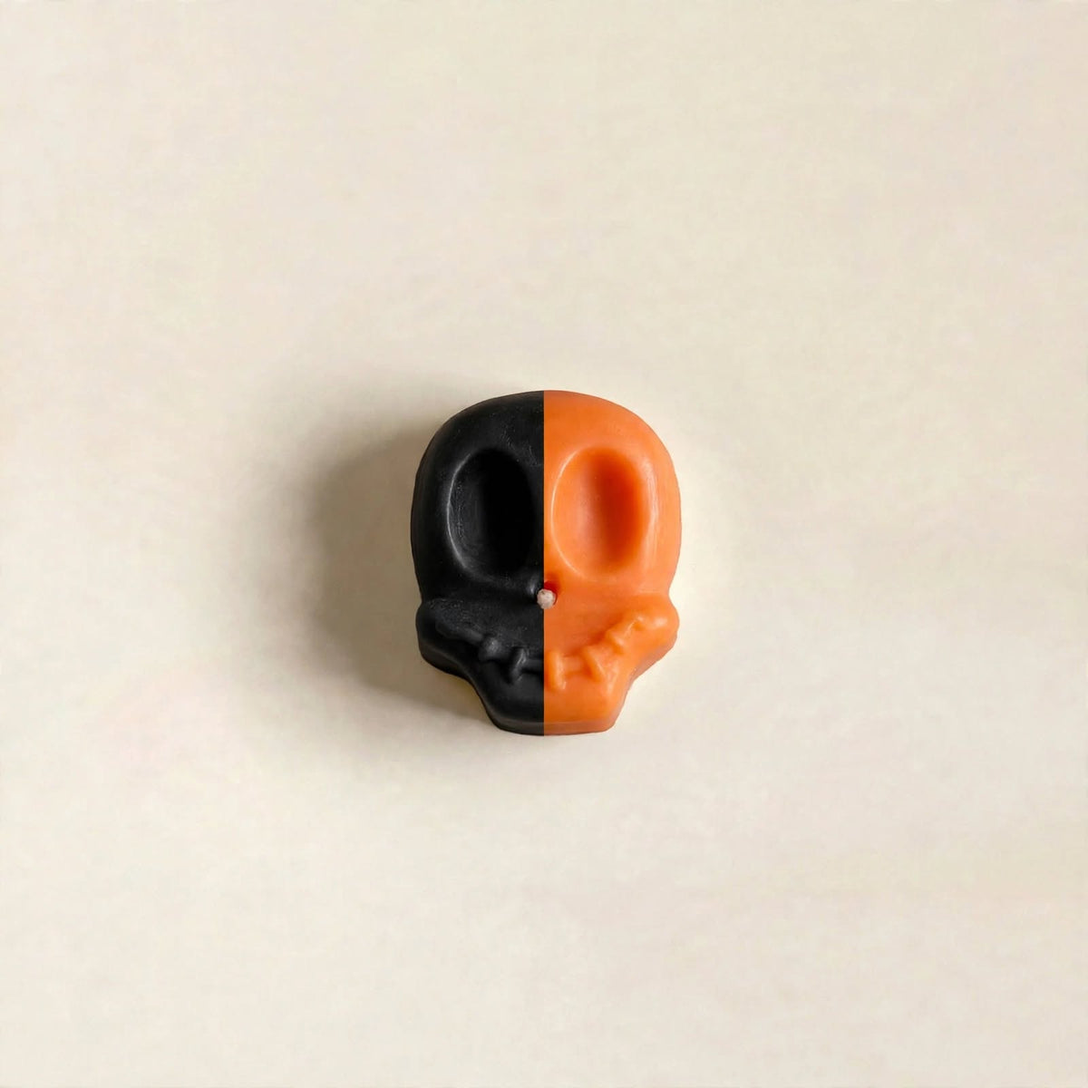 Yorick handmade Halloween candle by Glowbaltic, hand-poured black and orange rapeseed wax skull candle